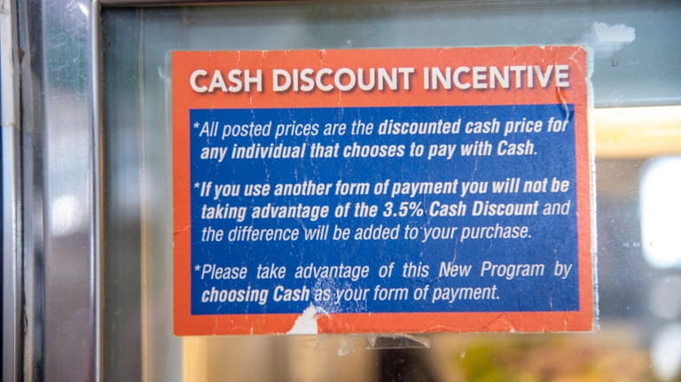 The "Cash Discount Incentive" sign inside the Bay Deli in...