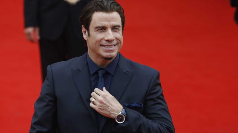 John Travolta arrives at the opening ceremony of the 48th...
