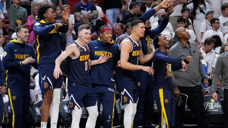 The Denver Nuggets celebrate during the second half of Game...