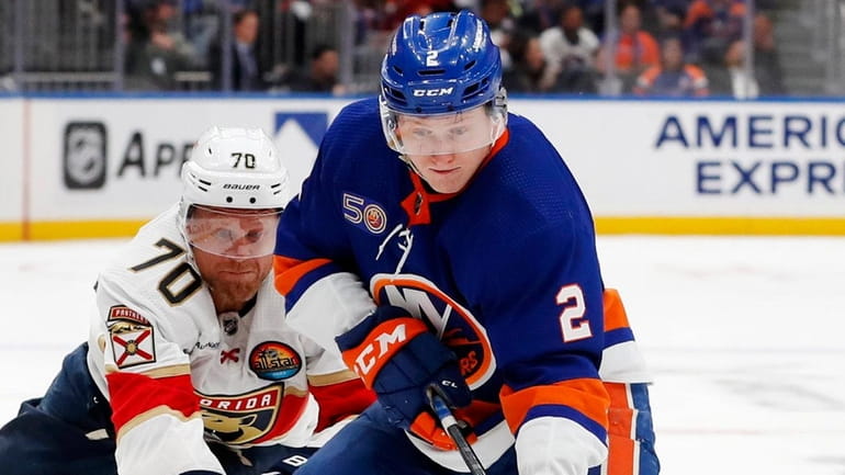 Robin Salo #2 of the Islanders plays the puck against Patric...
