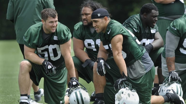 Left to right: Jets linebacker Garrett McIntyre, defensive tackle Sione...
