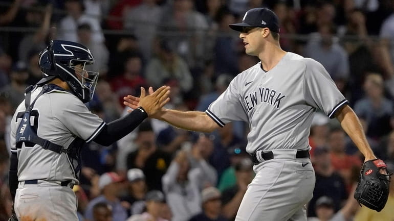 Yankees relief pitcher Clay Holmes is congratulated by catcher Jose...