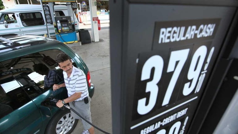 Jorge Montoya of Amityville fills up his gas tank at...