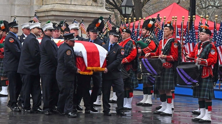 Firefighters carry the coffin of Capt. Christopher "Tripp" Zanetis in...