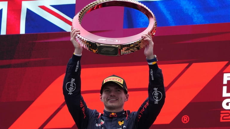 Red Bull driver Max Verstappen of the Netherlands celebrates on...
