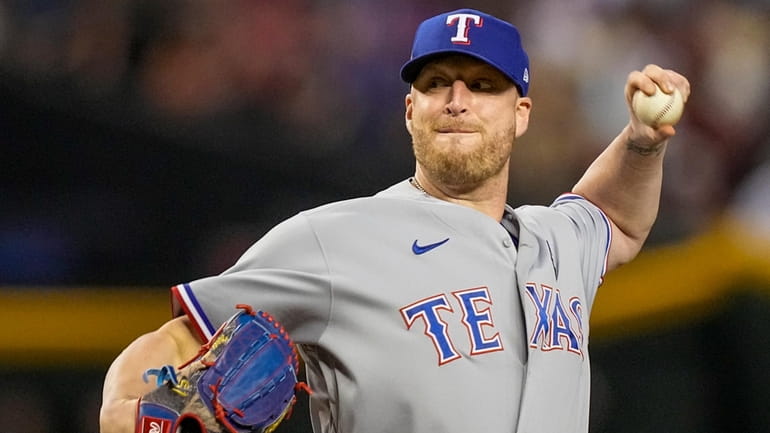 Texas Rangers relief pitcher Will Smith throws against the Arizona...