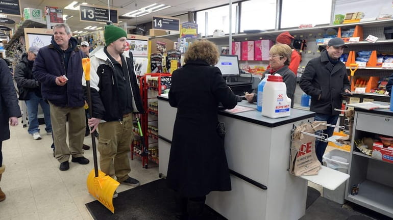 Shoppers stock up on ice melt and shovels as they...