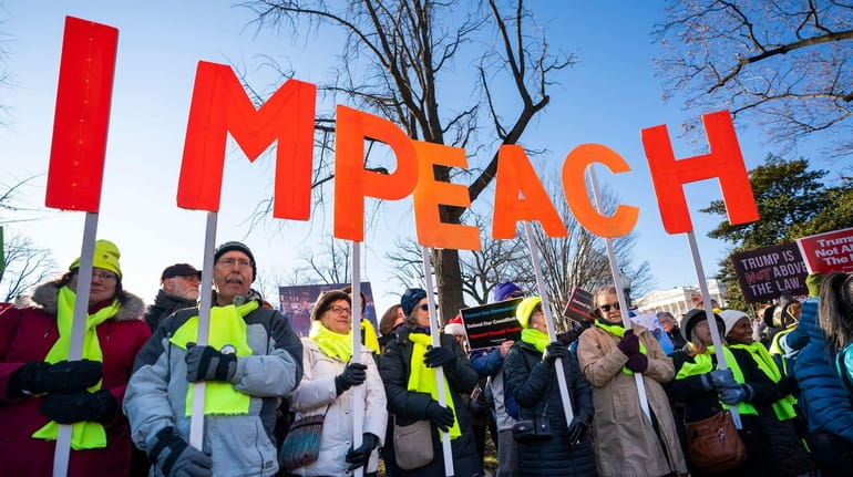 Activists gather at a 'Impeach and Remove' rally to show...