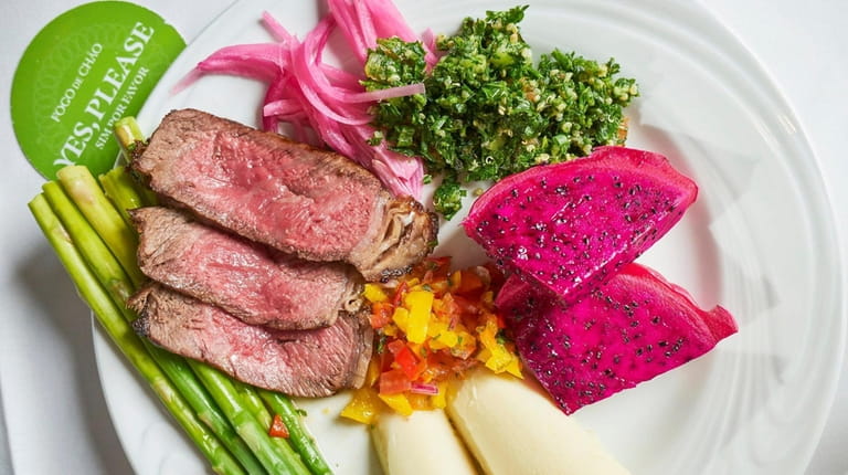 Sliced Wagyu steak with pickled onions, hearts of palm, and asparagus...