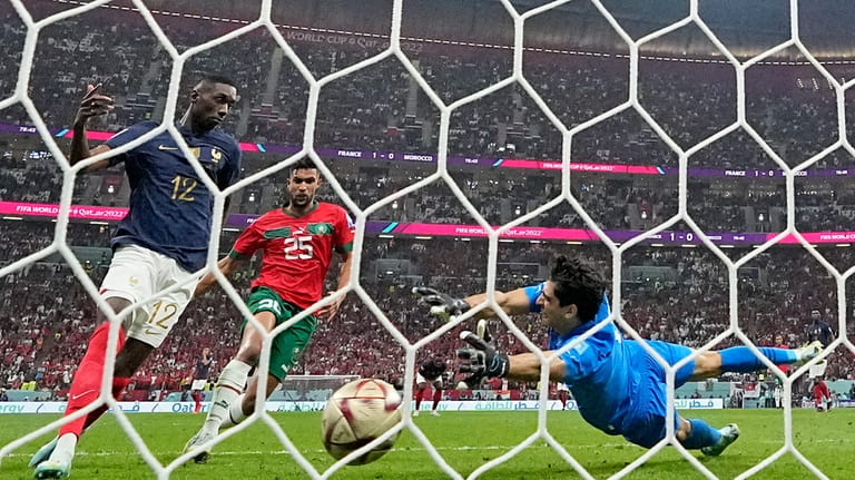 France's Randal Kolo Muani scores his side's second goal past...
