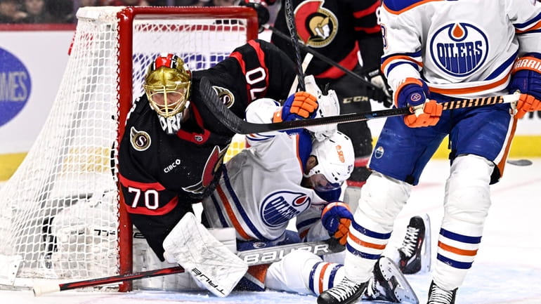 Edmonton Oilers center Connor McDavid (97) tries to get out...