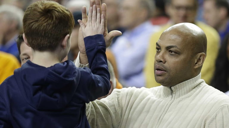 Former NBA basketball player Charles Barkley, right, greets a fan...
