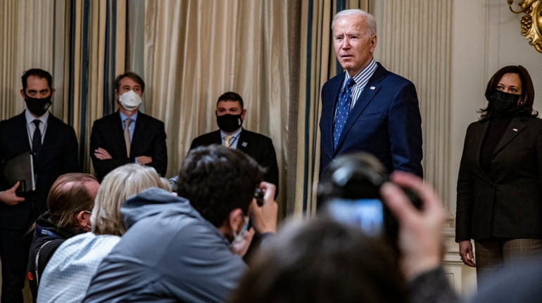President Joe Biden answers reporters' questions at the White House...