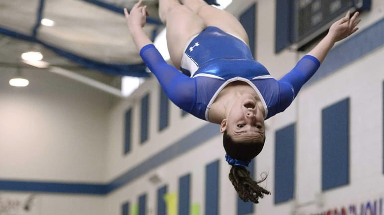 Ward Melville's Cydney Crasa competes on the vault during the...