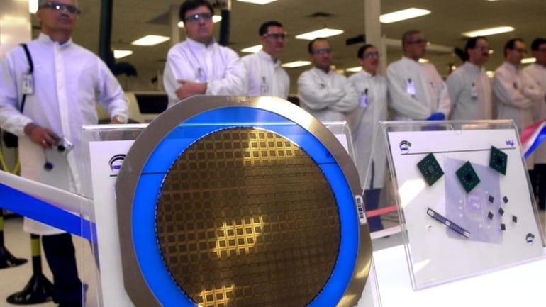 A wafer containing Pentium IV chips is seen as Intel...
