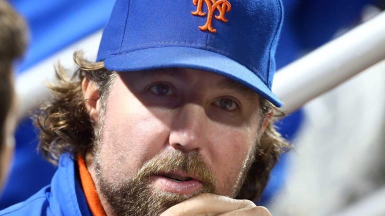R.A. Dickey looks on from the dugout during a game...