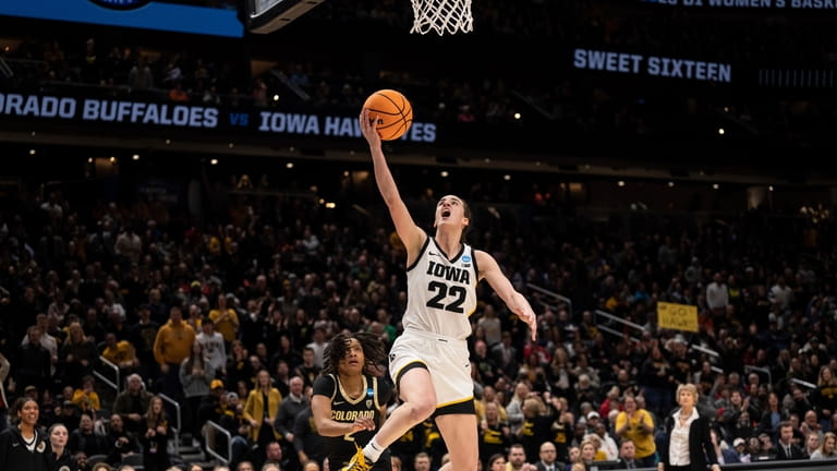 FILE - Iowa guard Caitlin Clark (22) goes up for...