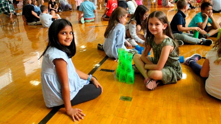 In Carle Place, third-graders at Rushmore Avenue Elementary School participate in a...
