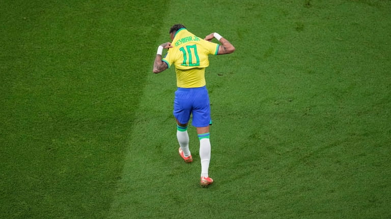 Brazil's Neymar wears his shirt during the World Cup group...