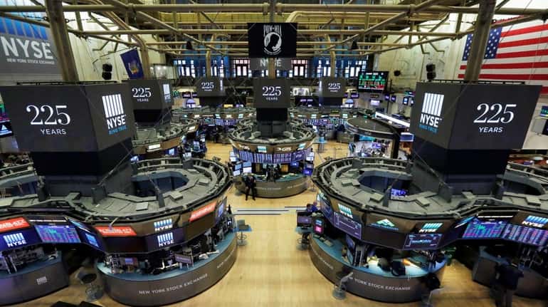 Traders work on the floor of the New York Stock...