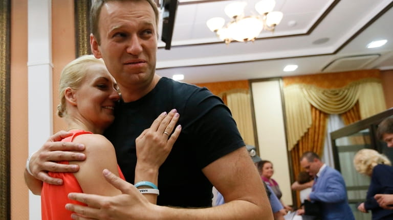 FILE- Russian opposition leader Alexei Navalny, right, embraces his wife...