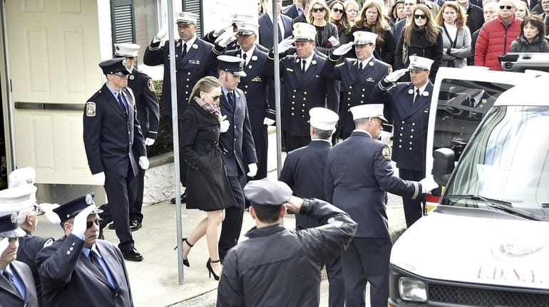 Eileen Davidson, wife of firefighter Michael Davidson, leaves his wake...
