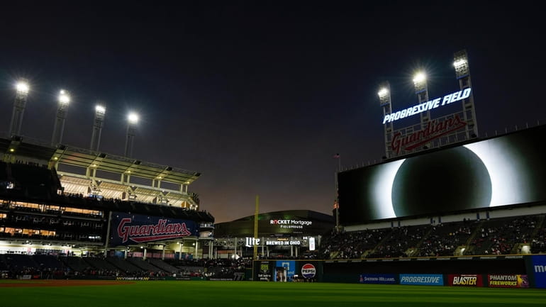The large video screen over Progressive Field displays the total...