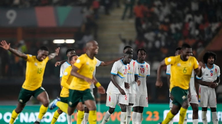DR Congo's players watches on as South Africa players celebrate...