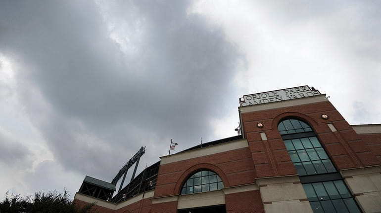 Storm clouds hover over Oriole Park at Camden Yards during...