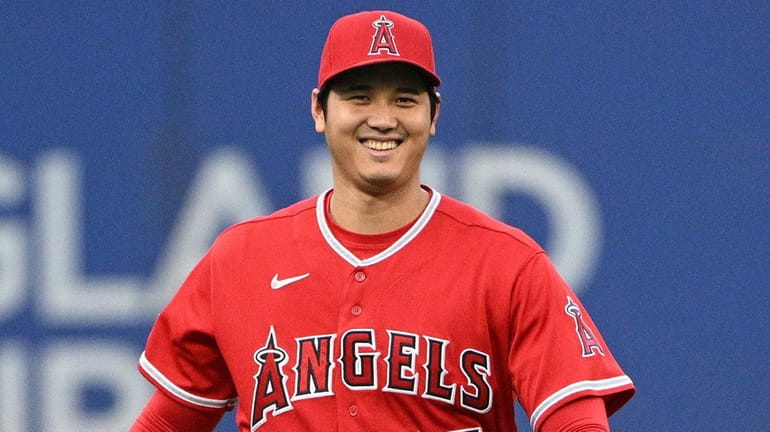 Los Angeles Angels designated hitter Shohei Ohtani looks on while...