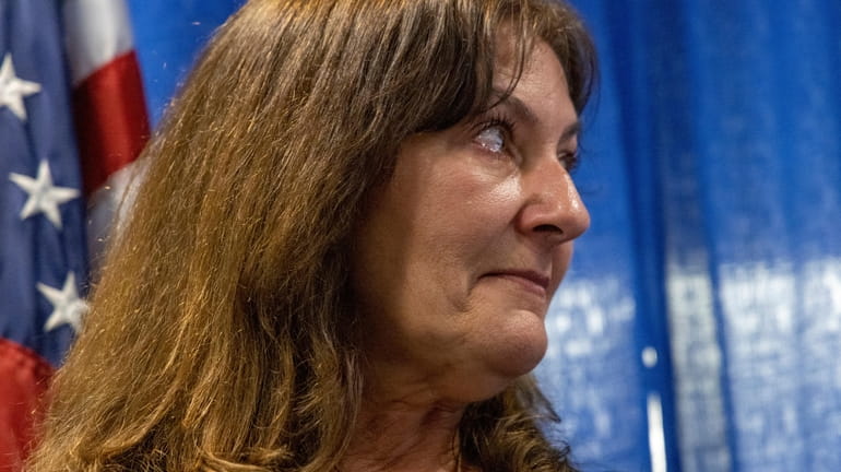 Darlene Altman weeps as Nassau County District Attorney Anne Donnelly announces...