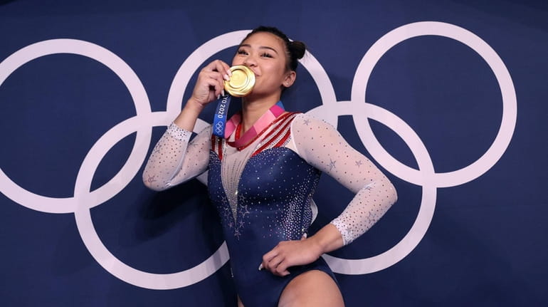 Sunisa Lee of Team USA poses with her gold medal...
