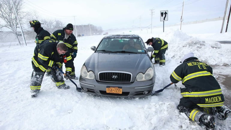 Firefighters from Nesconset and St. James help dig cars out...