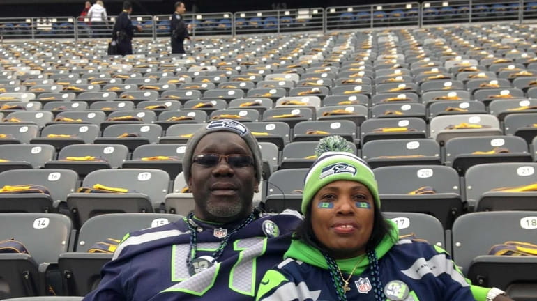 Bessie Lee, mother of Bruce Irvin, sits with her husband...