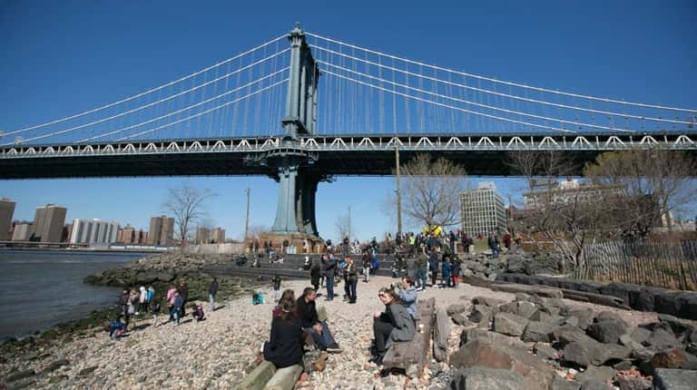 The Manhattan Bridge seen from Brooklyn Bridge Park in DUMBO,...