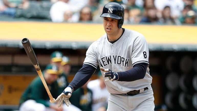 Mark Teixeira #8 of the New York Yankees throws the...