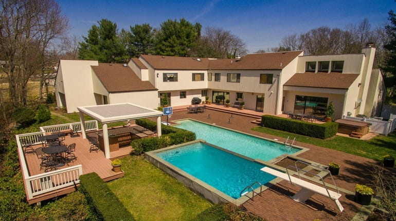 The 2.1-acre parcel includes a backyard with a diving pool...