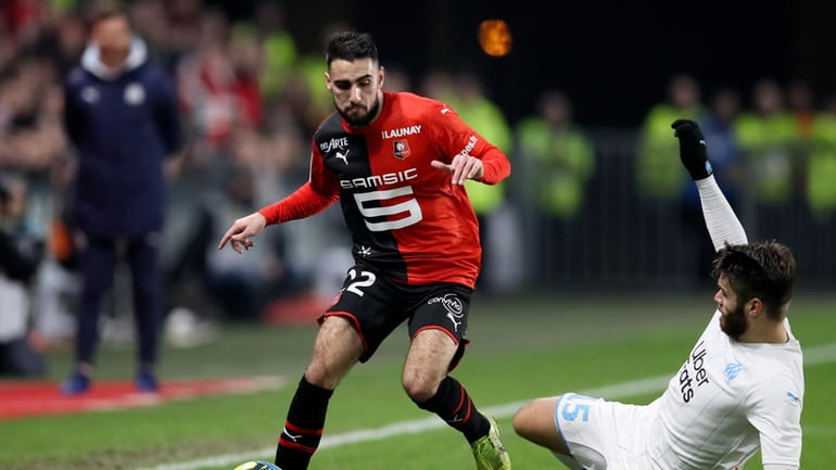 Rennes' Romain Del Castillo, left, duels for the ball with...