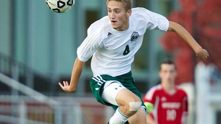 Carle Place forward Dylan Klein controls the ball in mid-air...