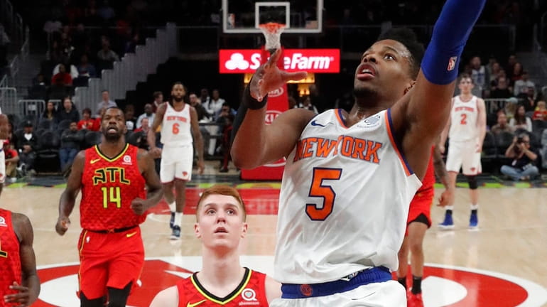 Knicks guard Dennis Smith Jr. goes in for a basket...
