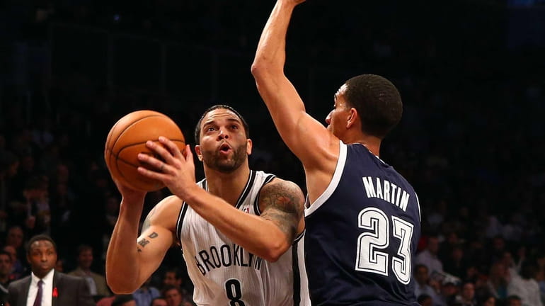 Deron Williams attempts a shot in front of the Oklahoma...