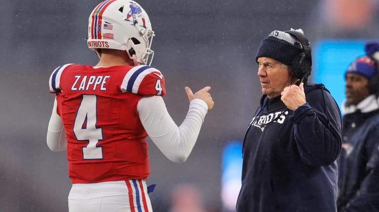 New England Patriots head coach Bill Belichick, right, talks with...