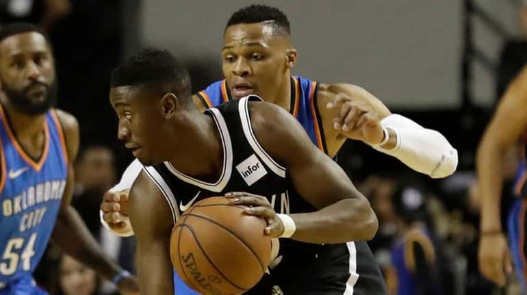 Brooklyn Nets' Caris Levert moves the ball across the court...
