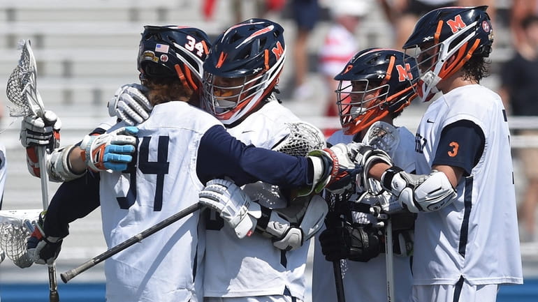 Manhasset teammates celebrate after their 14-4 win over South Side...