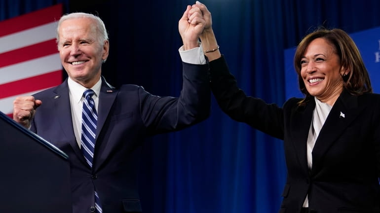 President Joe Biden and Vice President Kamala Harris stand on...