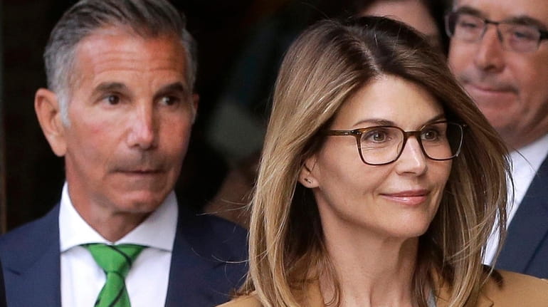 Actress Lori Loughlin and clothing designer husband Mossimo Giannulli, left, seen...