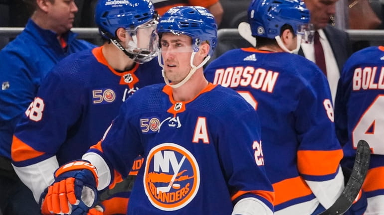 Islanders' Brock Nelson (29) skates past the bench after scoring...
