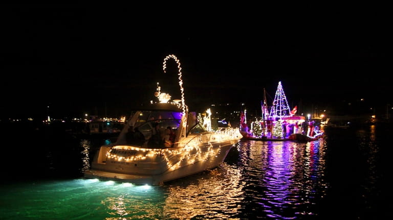 Decorated boats traveling on Huntington Harbor during the Huntington Harbor...