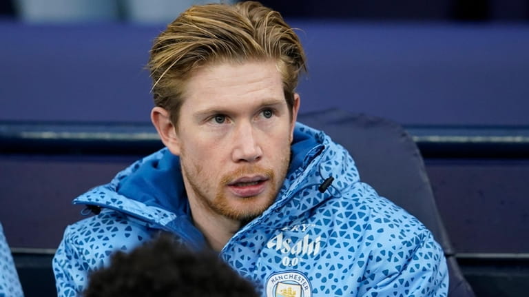 Manchester City's Kevin De Bruyne sits on the bench during...