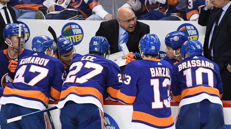 Islanders head coach Barry Trotz directs his players during a...